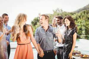 Happy young friends having drinks