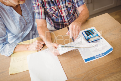 Senior couple checking their bills