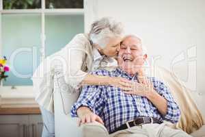 Senior woman embracing man at home