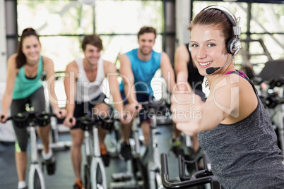 Fit group of people using exercise bike together