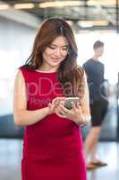 Beautiful young woman using mobile phone