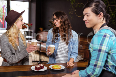 Smiling friends enjoying coffee and pastries