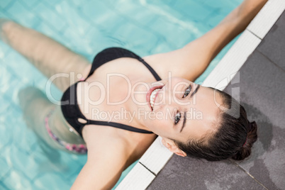 Pretty brunette relaxing on poolside