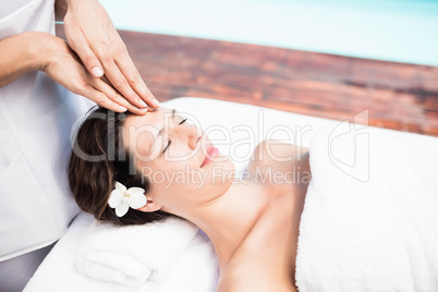 Woman receiving a head massage from masseur