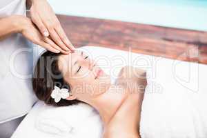 Woman receiving a head massage from masseur