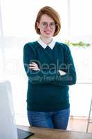 smiling hipster business woman with her arms crossed