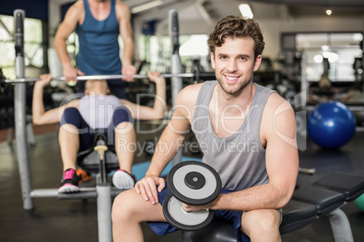 Fit man lifting dumbbell