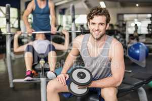 Fit man lifting dumbbell