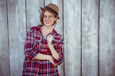 smiling hipster woman holding a pencil