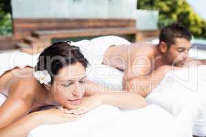 Young couple relaxing on massage table