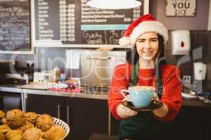 Cute waitress giving a coffee to customer