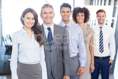 Business team standing in a row in office