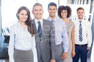 Business team standing in a row in office