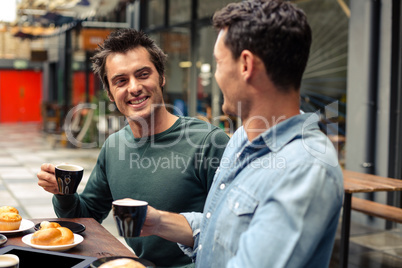 Happy friends having coffee together