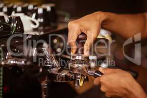 Close-up of barista preparing coffee