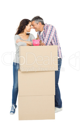 Couple with boxes and piggy bank