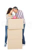 Couple with boxes and piggy bank