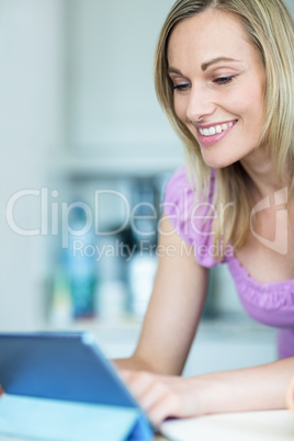 Pretty blonde woman using tablet computer