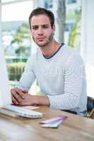 Handsome hipster working on computer