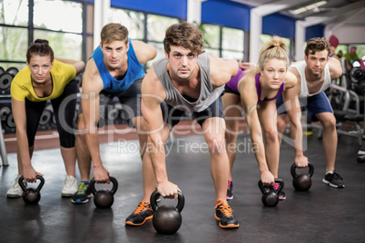 Fitness class lifting dumbbells