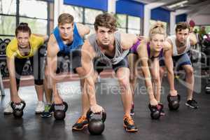 Fitness class lifting dumbbells