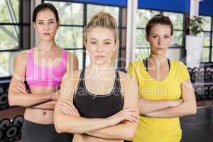 Athletic serious women posing arms crossed