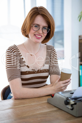 smiling hipster woman with a coffee cup