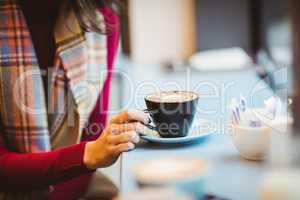 Woman holding a cup of coffee