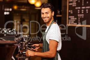 Handsome waiter serving coffee cup