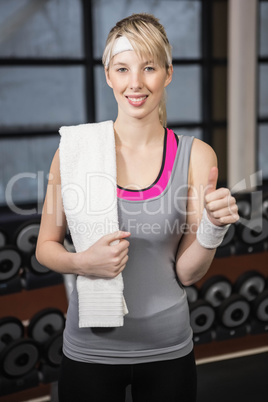 Smiling blonde showing thumb up