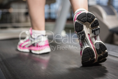 Feet of a woman on a treadmill