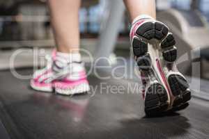 Feet of a woman on a treadmill