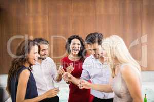 Young and handsome group of friends drinking shots