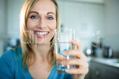 Pretty blonde woman drinking a glass of water