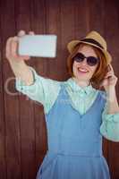 Cute red haired hipster taking a selfie