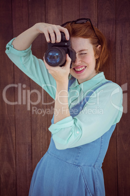 Red haired hipster taking picture