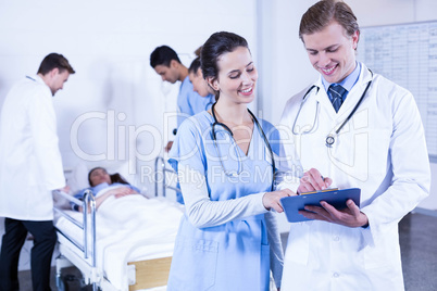 Doctor discussing paperwork on clipboard