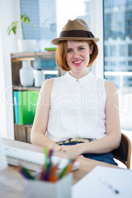 smiling hipster business woman wearing a trilby