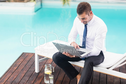 Smarty dressed man using laptop