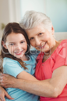 Portrait of grandmother and granddaughter embracing