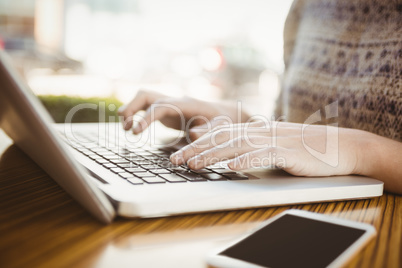 Close up of hands typing on a laptop