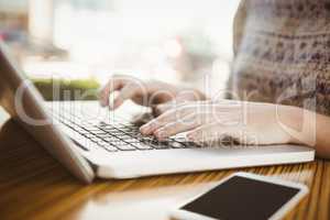 Close up of hands typing on a laptop