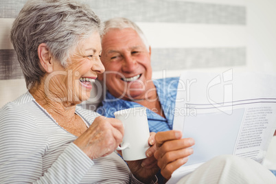 Senior couple reading newspaper