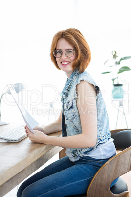 smiling hipster woman holding paperwork