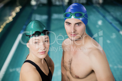 Couple in swimsuits looking at the camera