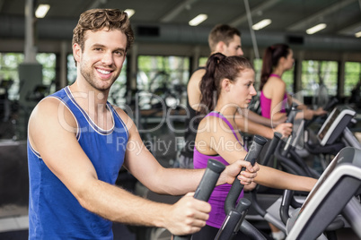 Fit people on elliptical bike