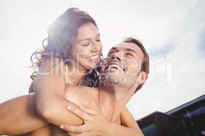Close-up of man giving piggy back to woman