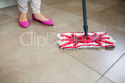 Woman swiping the kitchen floor