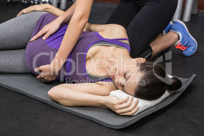 Trainer massaging pregnant woman