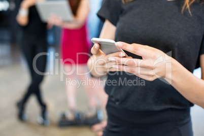 Businesswoman text messaging on smartphone